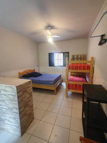 a bedroom with two bunk beds in a room at Pousada Astúrias in Ilha Comprida