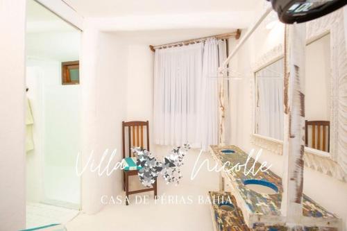 a room with a table and chairs and a window at Villa Nicolle - Bahia - Praia do Espelho in Praia do Espelho