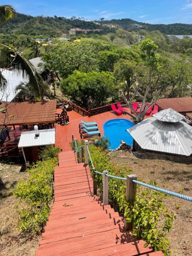 a wooden walkway leading to a playground with a pool at Hotel and Dive Center Roatan Yacht Club in Roatán