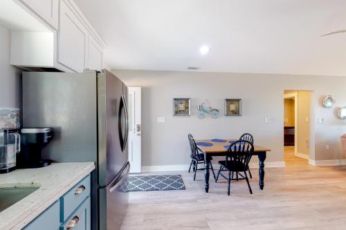 a kitchen with a table with chairs and a refrigerator at Isle of View in Mexico Beach