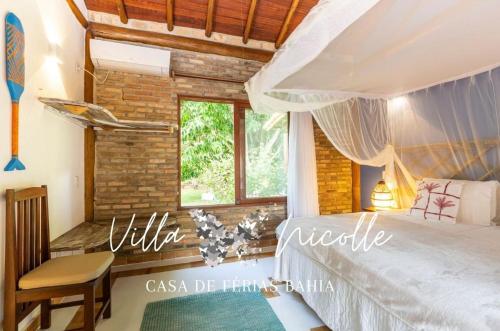 a bedroom with a white bed and a window at Villa Nicolle - Bahia - Praia do Espelho in Praia do Espelho
