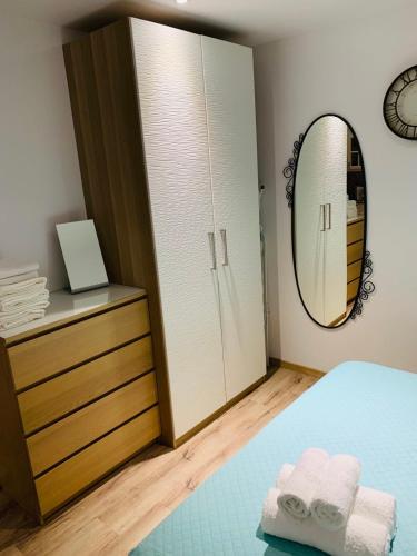 a bedroom with a mirror and a bed and a dresser at STUDIO in CAPTAINS HOUSE WITH A POOL in Limassol