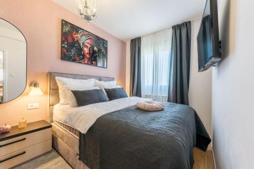 a bedroom with a large bed and a mirror at Apartment Emma with sauna in Zagreb