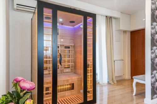 a wine cellar in a room with a glass door at Apartment Emma with sauna in Zagreb