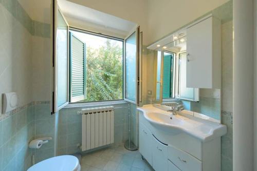 a bathroom with a sink and a window at La Casa del Sole sul mare di Ischia in Ischia