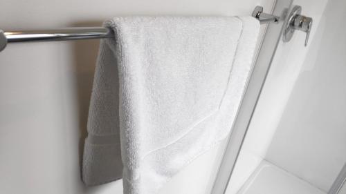 a towel hanging on a towel rack in a bathroom at Drury Motor Lodge in Drury