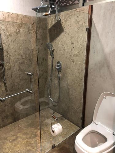 a bathroom with a shower and a toilet at Gamma Monterrey Rincon de Santiago in Santiago