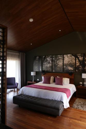 a bedroom with a large bed and a large window at Gamma Monterrey Rincon de Santiago in Santiago
