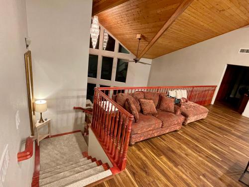 a living room with a brown couch in a house at Stunning 3,400 sq ft Lake House w Boat Dock, Sauna, Steam Shower, and More in Clearlake Oaks