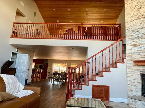 a living room with a staircase in a house at Stunning 3,400 sq ft Lake House w Boat Dock, Sauna, Steam Shower, and More in Clearlake Oaks
