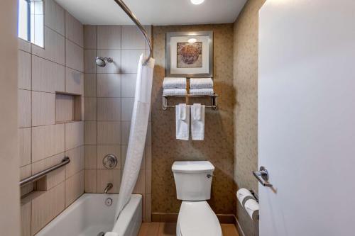 a bathroom with a tub and a toilet and a sink at Best Western Plus Anaheim Inn in Anaheim
