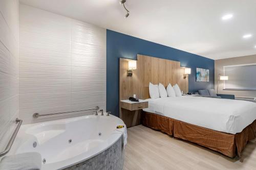 a hotel room with a bed and a bath tub at Best Western Plus Edinburg Inn & Suites in Edinburg
