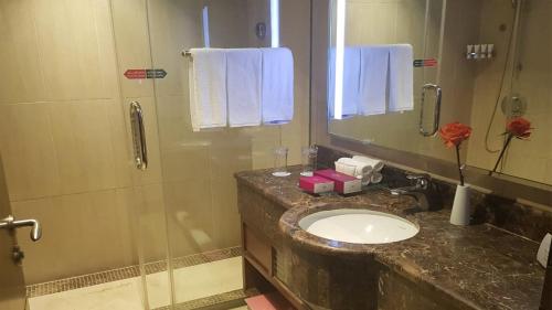 a bathroom with a sink and a shower at Crowne Plaza Madinah by IHG in Al Madinah