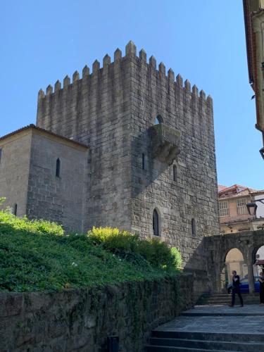 a man walking past a large stone castle at Lost Inn Porto Hostel in Porto