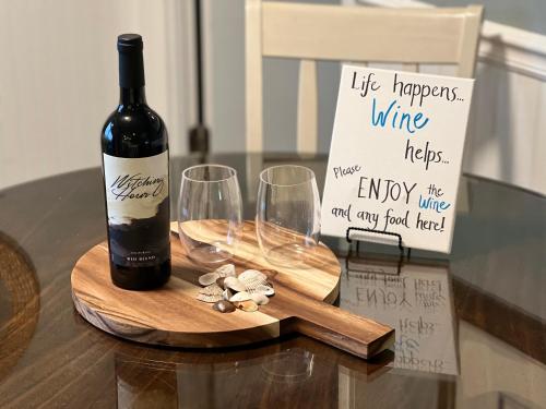 
a bottle of wine and a bottle of wine sit on a table at Myrtle Beach Resort - 2 Bedroom 2 Bath With Fantastic Amenities in Myrtle Beach
