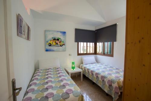 a bedroom with two beds and a window at Serenity Garden in Maspalomas