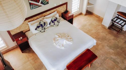 an overhead view of a white bed with pillows at Saletoga Sands Resort & Spa in Matatufu