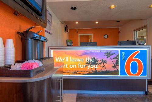 a sign for a fast food restaurant with a television at Motel 6-San Ysidro, CA - San Diego - Border in San Ysidro