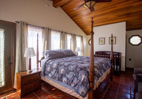 a bedroom with a bed and a wooden ceiling at The Chateau in Bloomington