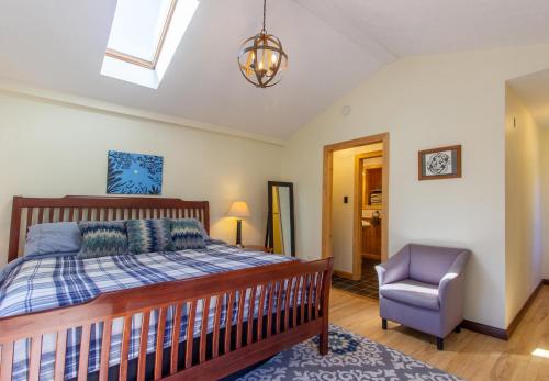 a bedroom with a bed and a chair at The Chateau in Bloomington