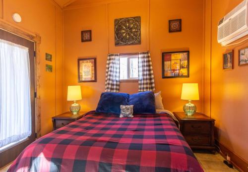 a bedroom with a bed and two lamps on tables at The Chateau in Bloomington