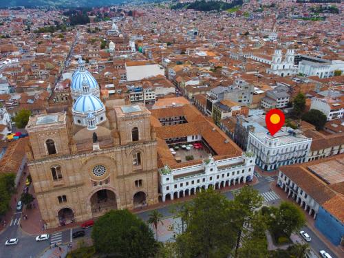 an aerial view of a city with a red marker at Del Parque Hotel & Suites in Cuenca
