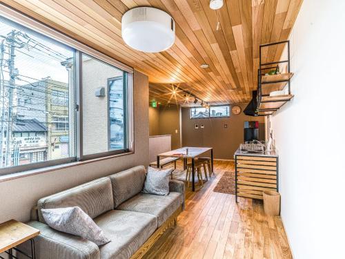 a living room with a couch and a table at Rakuten STAY HOUSE x WILL STYLE Matsue 102 in Matsue
