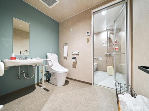 a bathroom with a toilet and a sink and a shower at Rakuten STAY Naha-Miebashi Accessible Twin Room in Naha