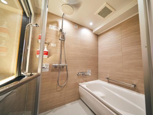 a bathroom with a shower and a bath tub at Rakuten STAY Naha-Miebashi Twin Room in Naha