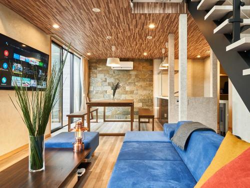 a living room with a blue couch and a table at Rakuten STAY VILLA Lake Yamanakako 104 Pets allowed with dog run in Yamanakako