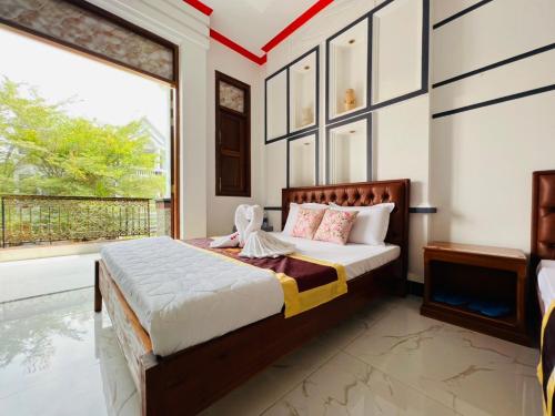 מיטה או מיטות בחדר ב-Đại Quang Hotel