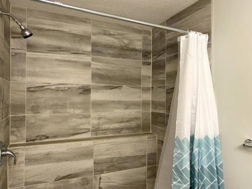 a bathroom with a shower with a shower curtain at Beautiful and Spacious 1 room in a very quiet area in Airdrie