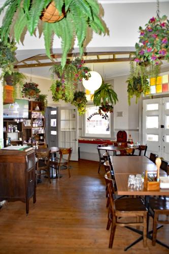 a restaurant with tables and chairs and potted plants at Ten Dollar Town Motel in Gulgong