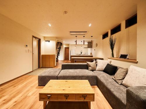 a living room with a couch and a table at Rakuten STAY HOUSE Kujukuri Ichinomiya 105 3LDK with BBQ terrace in Ichinomiya