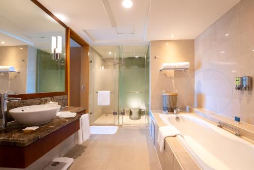 a bathroom with a sink and a tub and a shower at Park Plaza Beijing Wangfujing in Beijing