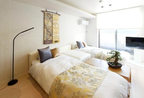 En eller flere senge i et værelse på Libre Hosai Stay Kanazawa - Vacation STAY 3357