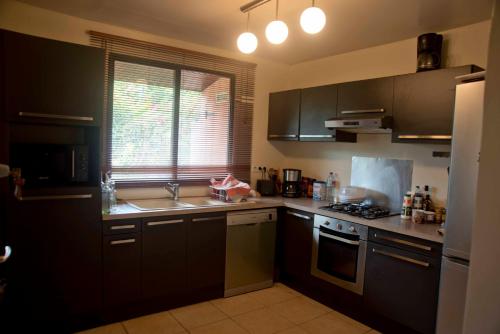a kitchen with a sink and a stove top oven at ROYAL HERE in Faaa