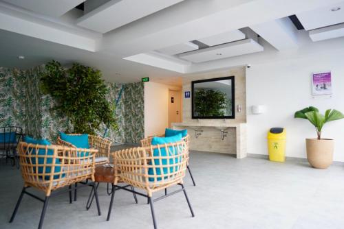 a room with chairs and a table and a mirror at Apartemen MATARAM CITY YUDHISTIRA TOWER YOGYAKARTA in Kejayan