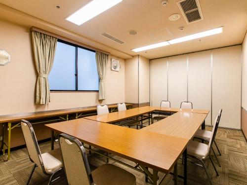 a conference room with tables and chairs and a large window at Hotel Wing International Nagoya in Nagoya