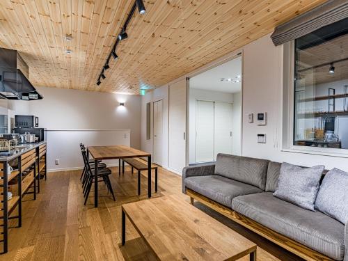a living room with a couch and a table at Rakuten STAY HOUSE x WILL STYLE Itoshima 103 in Itoshima