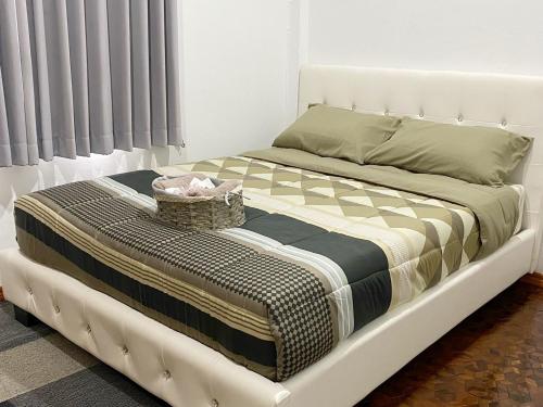 a white bed with a basket on top of it at Boxsoon Nimman 2 # 4beds 3baths in Chiang Mai