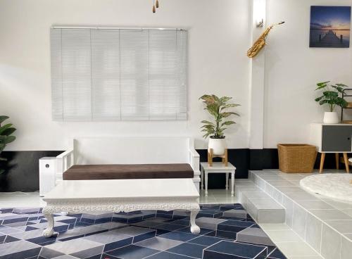 a room with a white bench and a blue tile floor at Boxsoon Nimman 2 # 4beds 3baths in Chiang Mai
