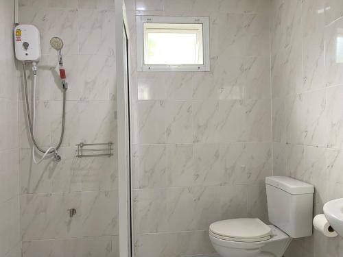 a bathroom with a shower and a toilet and a window at Boxsoon Nimman 2 # 4beds 3baths in Chiang Mai