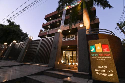 a building with a sign in front of it at Stay Studio Hotel & Residences in Gurgaon