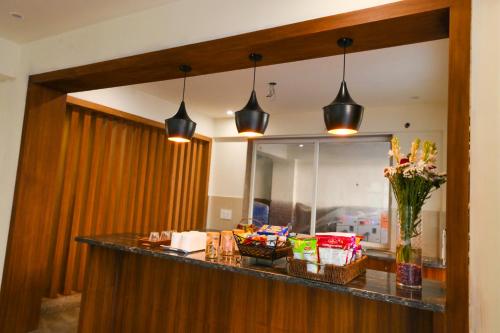 a lobby with a counter with snacks and a mirror at Stay Studio Hotel & Residences in Gurgaon