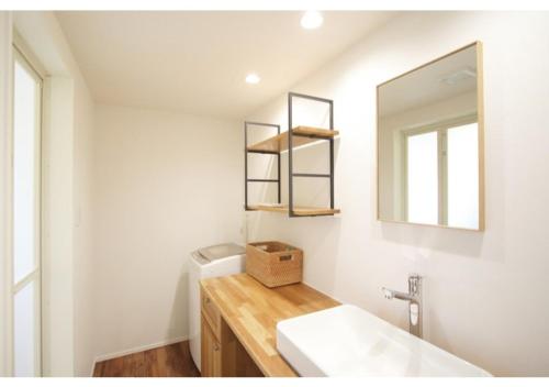 a bathroom with a sink and a mirror at Rakuten STAY HOUSE x WILL STYLE Fujiyoshida Matsuyama 101 in Fujiyoshida