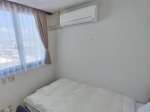 Postel nebo postele na pokoji v ubytování Hotel Hakusan Hills