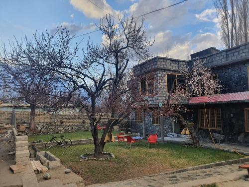 a house with a tree in front of it at Sehrish Guest House Skardu in Skardu