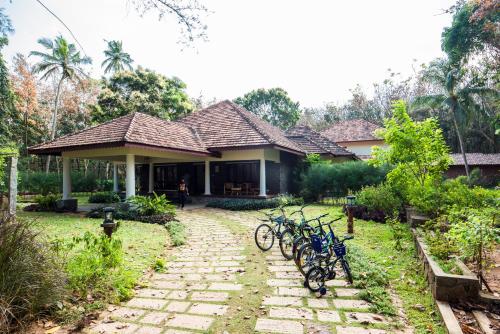 a house with bikes parked in front of it at Vaikundam Legacy in Kaliyal