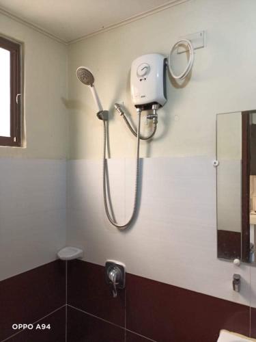 a shower head on the wall of a bathroom at Alles One Oasis Condo Davao Near SM Mall with Wifi in Davao City